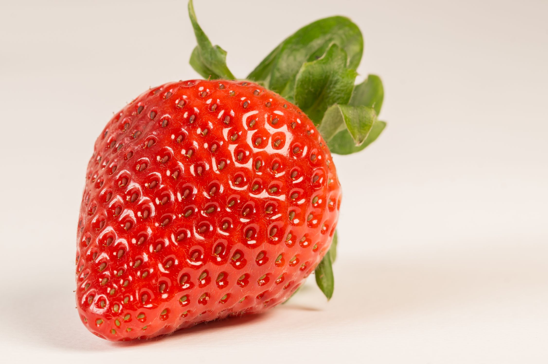 Close-up of small wild strawberries with textured surface